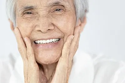 woman smiling with her new all-on-4 dental implants
