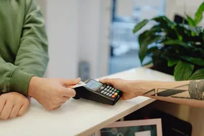 man paying for his dental appointment