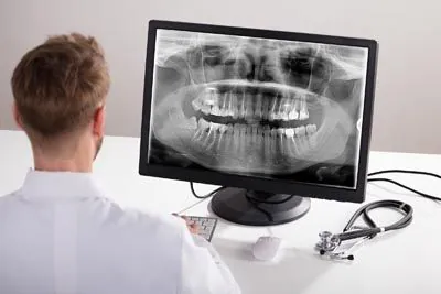 dentist reviewing a patient's dental x-rays