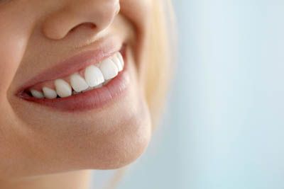 closeup of a woman's restored smile thanks to services offered at Smile Source North