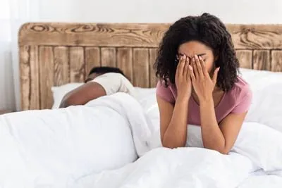 woman awake at night due to her husband's snoring