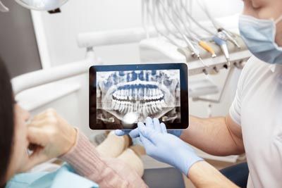 dentist showing a patient her dental x-rays