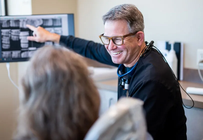 Dr. Jeff Henneberg showing a patient their dental x-rays at Smile Source South Hill