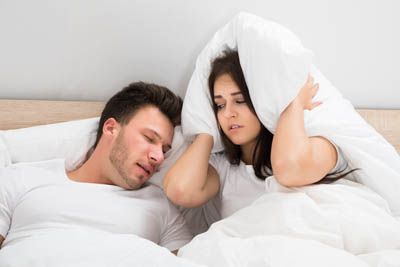 woman wide awake at night due to her husband's snoring