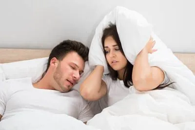 woman wide awake at night due to her husband's snoring