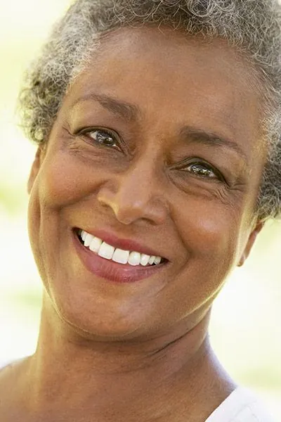 woman smiling with her all-on-4 dental implants