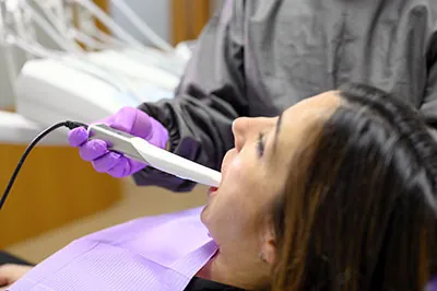 patient receiving a dental checkup using an intraoral camera