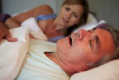 man snoring causing his wife to be wide awake at night